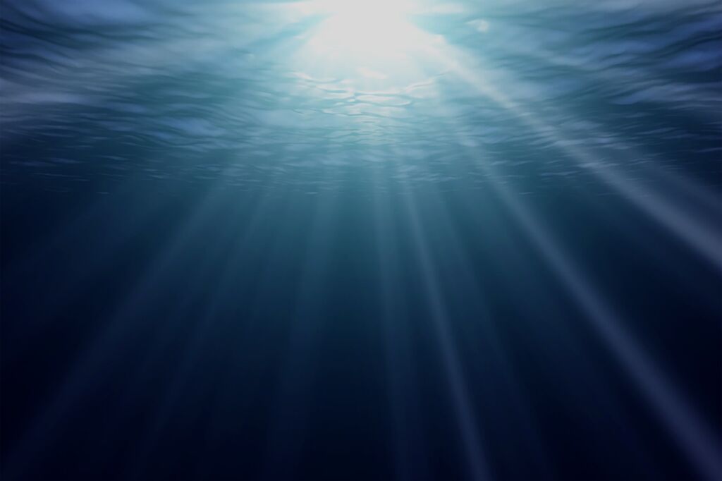 Rays of sun under water. The ocean is quiet.